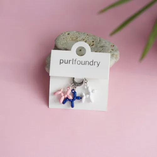 Navy, pink and white knit stitch markers in the shape of balloon animals